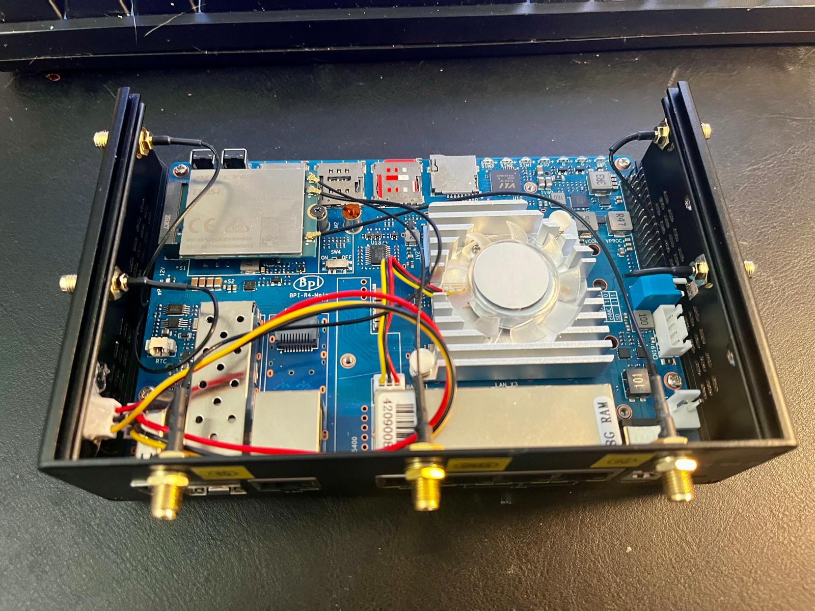 The BPI-R4 with the top off, a Quectel EM05 LTE modem in the M.2 slot next to the SIM holders.